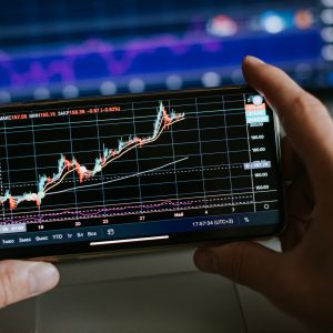 trader analyzing stock trading graph phone app